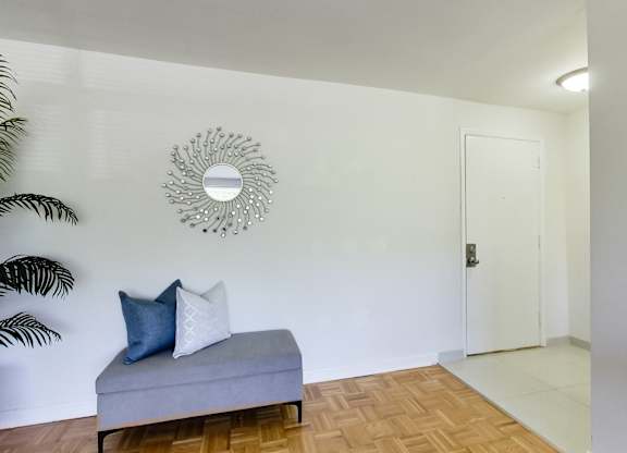 a living room with a couch and a mirror on the wall