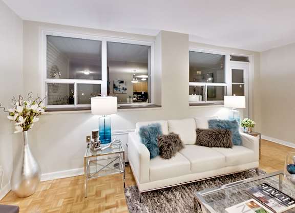 a living room with a couch and a glass table