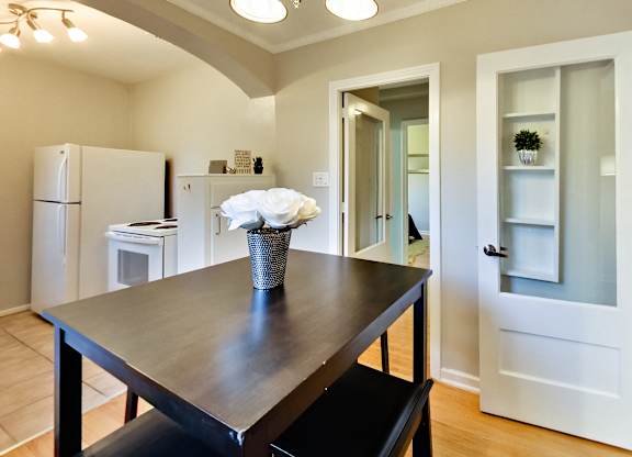 a dining room with a table and a kitchen