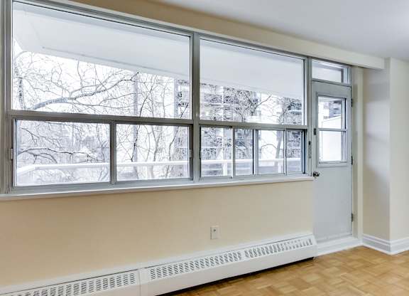 A room with a window overlooking a snowy landscape.