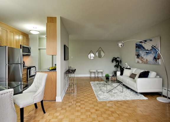 a living room with a couch and a table and a kitchen
