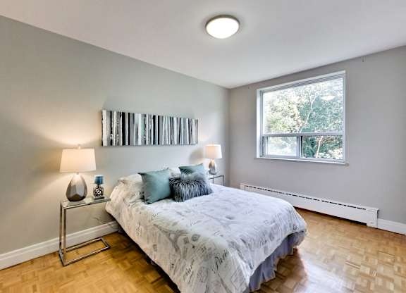 a bedroom with a bed and a window