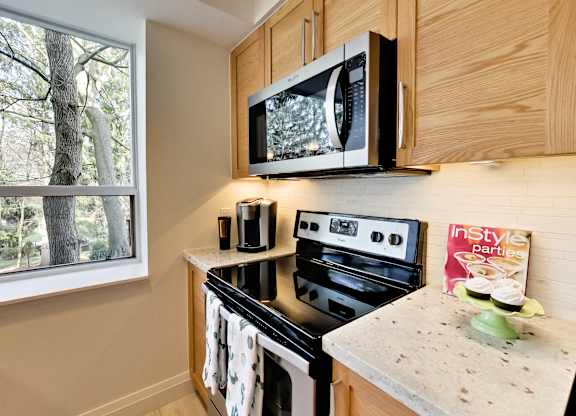 a kitchen with a stove microwave and a window