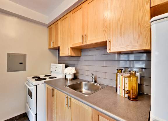 a kitchen with white appliances and wooden cabinets