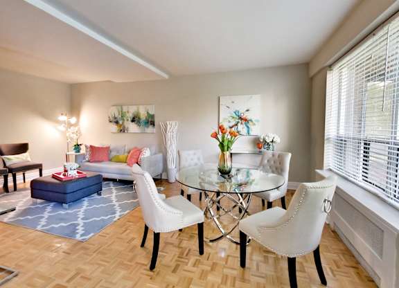 a living room with a table and chairs and a couch