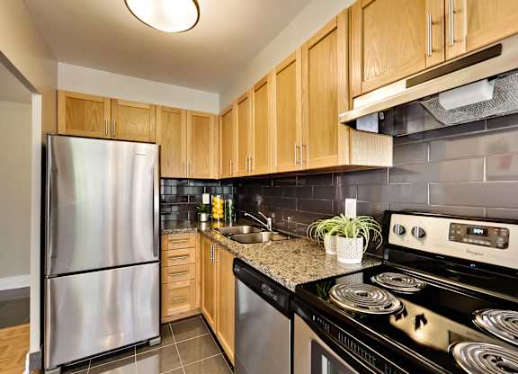 a kitchen with stainless steel appliances and wooden cabinets