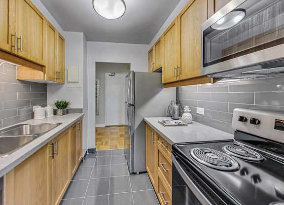 a kitchen with stainless steel appliances and wooden cabinets
