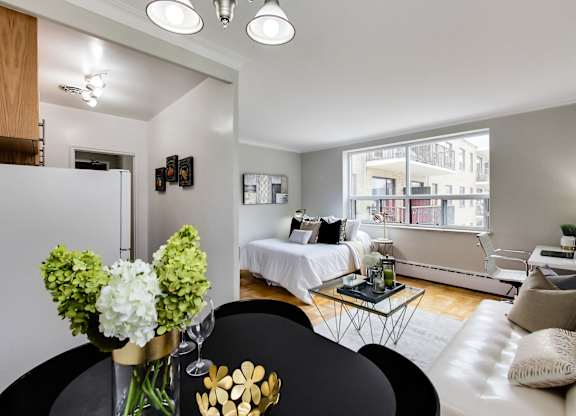 a living room with a couch and a table and a bed