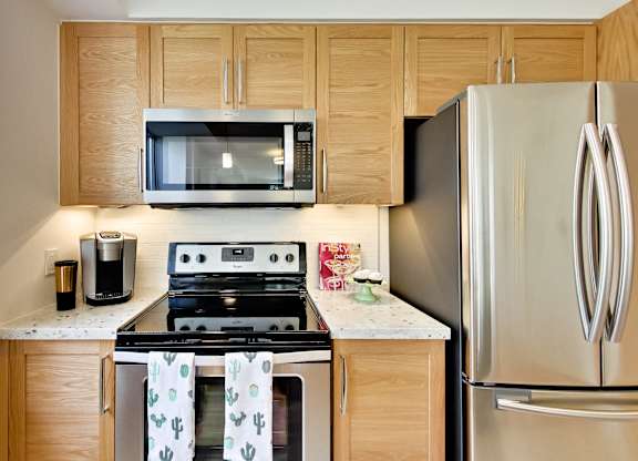 a kitchen with stainless steel appliances and wooden cabinets