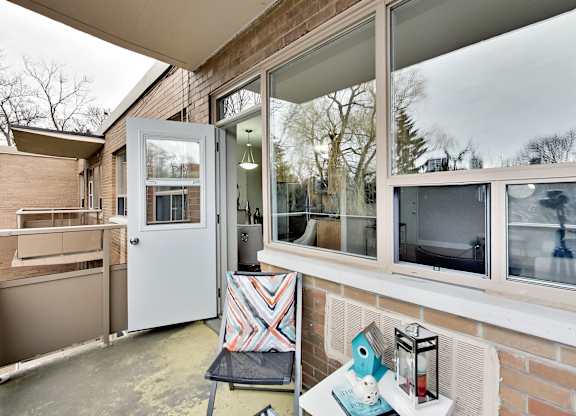 a small porch with a white door and a kitchen