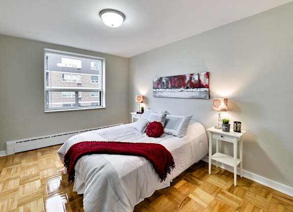 a bedroom with a white bed and a window