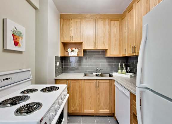 a kitchen with white appliances and wooden cabinets