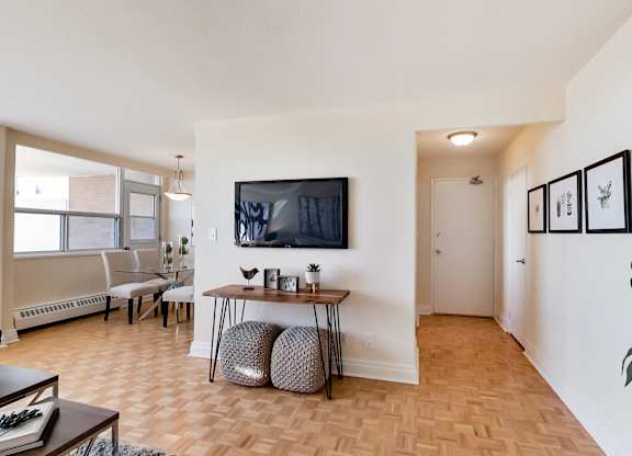 A living room with a wooden floor and a white wall.