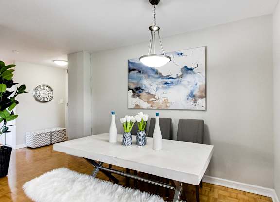 a dining room with a white table and a white rug