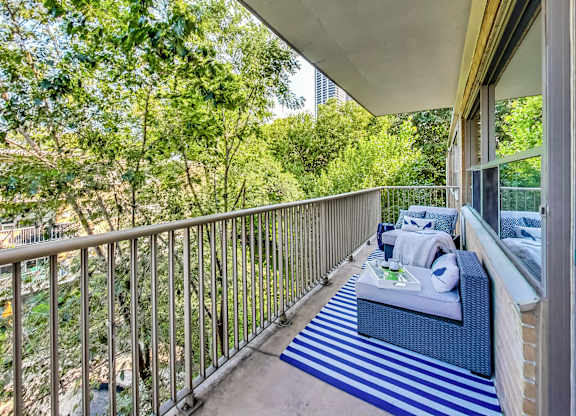 a balcony with a couch and a table on it