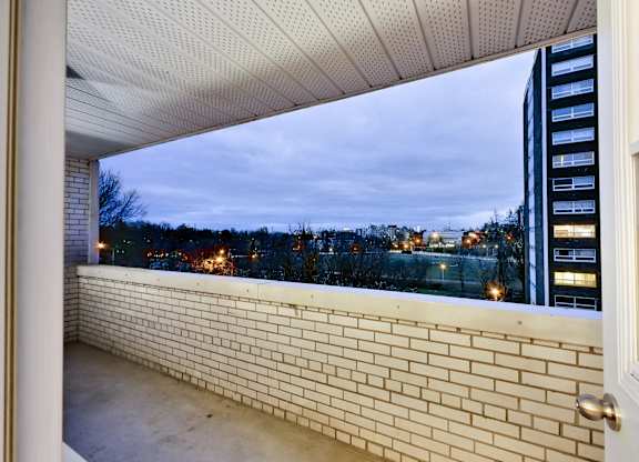 a balcony with a view of a city at night