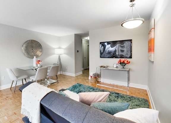 A living room with a grey couch and a white coffee table.