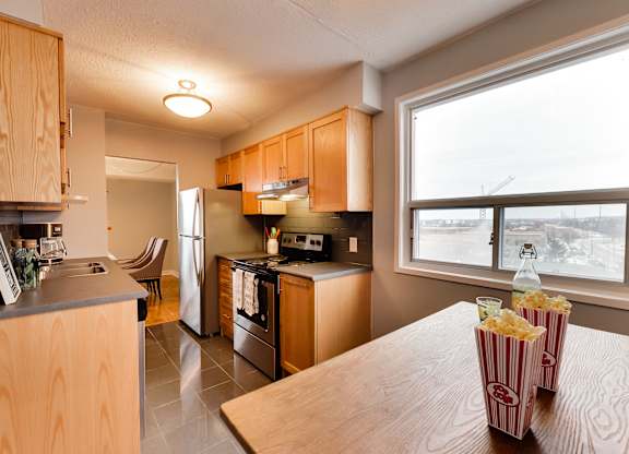 full kitchen with stainless steel appliances and a large window