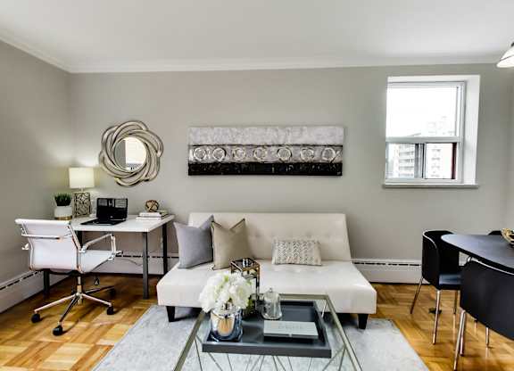 a living room with a white couch and a glass coffee table