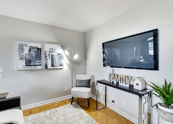an apartment living room with a large tv and a couch
