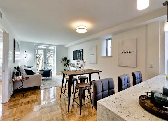 a living room and dining room with a table and chairs