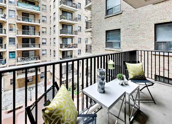 a patio with a table and chairs on a balcony