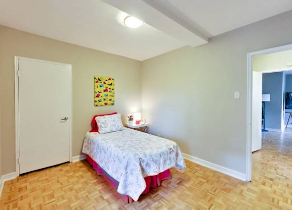 a bedroom with a bed and a door to a bathroom