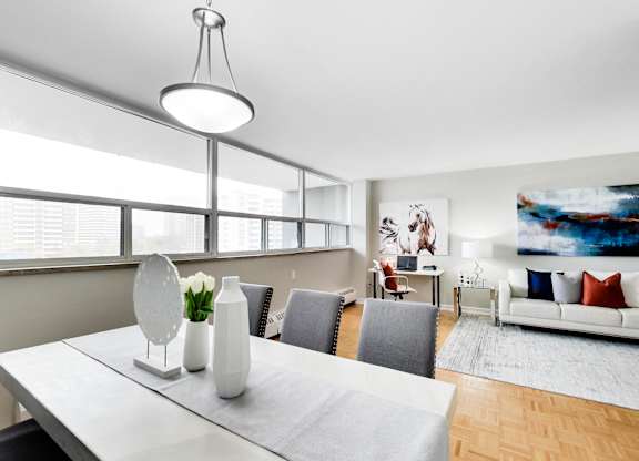 a living room with a white table and chairs and a large window