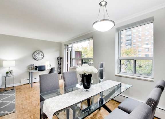 a dining room with a glass table and chairs