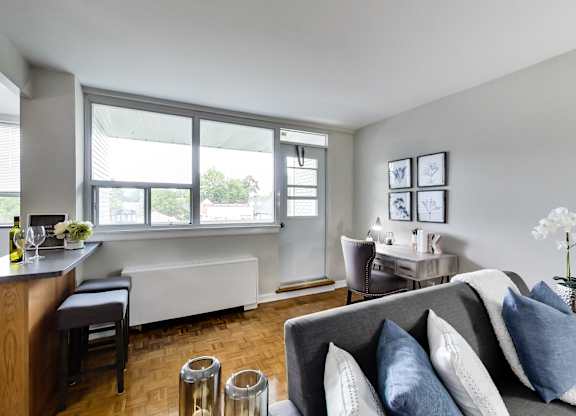 a living room and dining room with a couch and chairs and a table with chairs