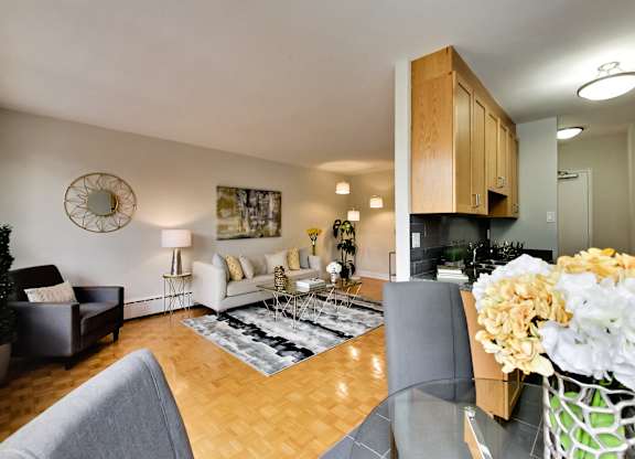 a living room with a glass dining room table and a couch