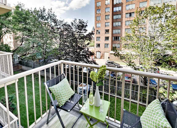 a balcony with two chairs and a table on it