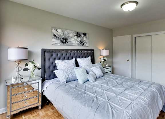 the master bedroom has a large bed and a large closet