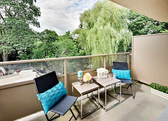 a patio with a table and chairs on a balcony