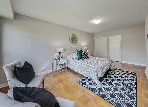 a bedroom with a bed and a couch and a chair