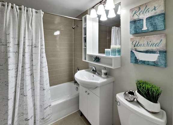 a bathroom with a sink toilet and a tub