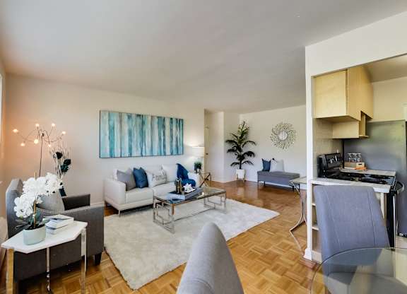 a living room with couches and chairs and a table