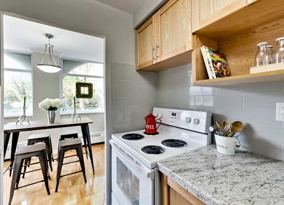 A kitchen with a white stove top oven and a counter top.