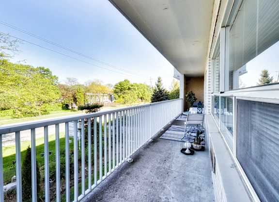 the view from the balcony of a large apartment building with a view of the yard