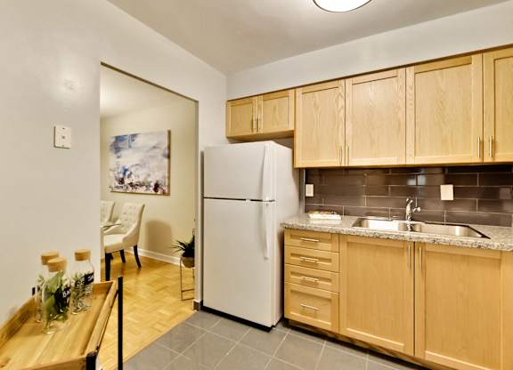 a kitchen with wooden cabinets and a white refrigerator