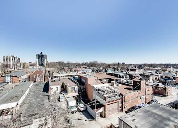 A cityscape with buildings and cars.