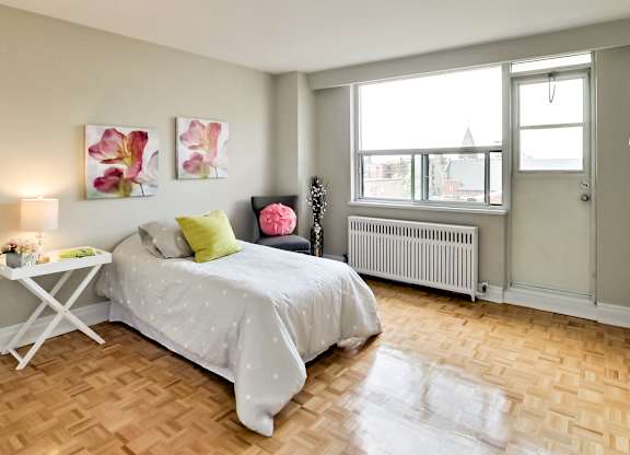 a bedroom with a bed and a window