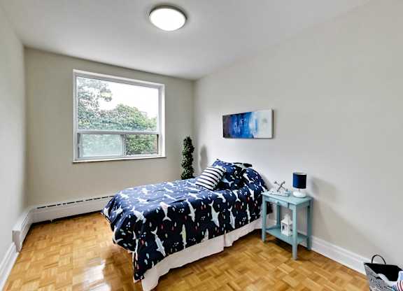a bedroom with a bed and a window