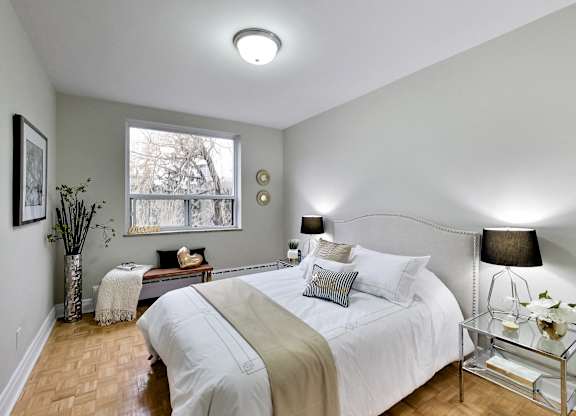 a bedroom with a large bed and a window