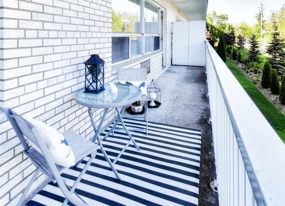 a small patio with a table and chairs on it