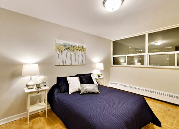 a bedroom with a large bed and a window