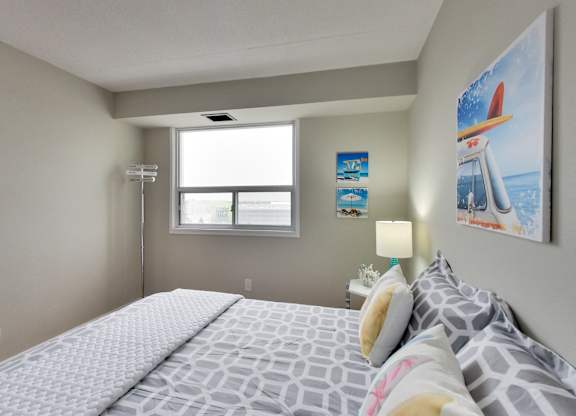 a bedroom with a large bed and a window