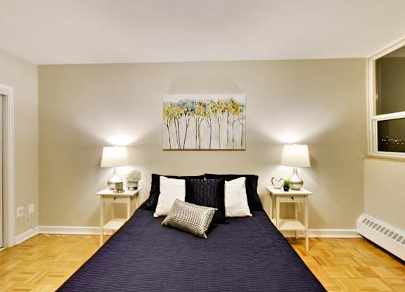 a bedroom with a large bed with a blue blanket and pillows