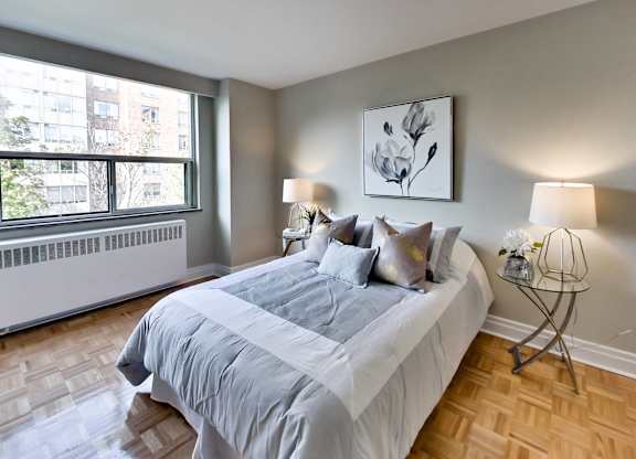 a bedroom with a large bed and a window