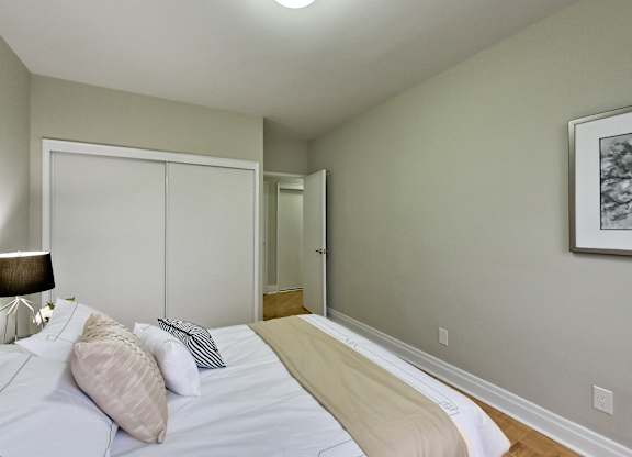 a bedroom with a large bed and a door to a bathroom